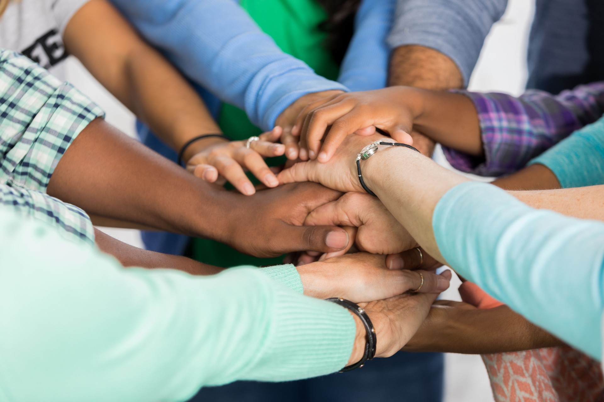 Team of people with hands together
